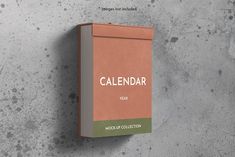 a box with the word calendar on it is hanging up against a concrete wall in an empty room