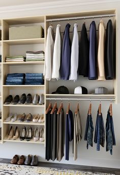 an organized closet with clothes and shoes