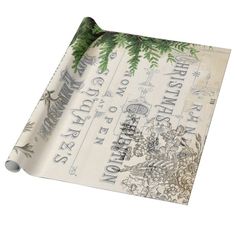 christmas wrapping paper with evergreens and snowflakes printed on the bottom, in white