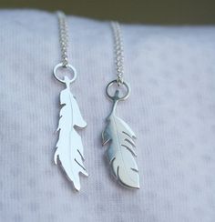 This listing price is for 1 silver feather pendant.  Please choose which feather you prefer (left or right from 1st pic), or you can order both.-d e s c r i p t i o n-These little feathers are handmade from scratch using traditional metalsmithing techniques.The sterling silver is melted & rolled into sheet and the feather shapes are hand cut with my saw and engraved by me.These petite pendants measure roughly 2.5cm tall.If you order more than one, I will provide different length chains for a lay Silver Feather Necklace, Tropical Jewelry, Feather Necklace, Hood Ornaments, Feather Pendant, Silver Feather, Feather Necklaces, P T, Left Or Right