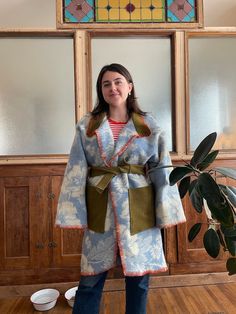 Handmade Vintage Blanket Coat 100% Wool Winter Women's. Handsewn floral blue and off-white. Belted with pockets. Fits S/M/L long wrap style blanket coat made from a vintage blanket, floral pattern. I used an olive green army surplus jacket for the pocket and collar, and did a blanket stitch with wool along the edges. The tie goes internally on the back for a beautiful flow in pattern on the back when tied.  Size small: fits over sized Size medium: fits slightly over sized Size large: fits true to size One of a kind, there's no other one like this! From the brain and heart of Erin Wakeland Diy Blanket Jacket, Blanket Coat Pattern, Army Surplus Jacket, Wool Blanket Coat, Long Quilted Coat, Blanket Jacket, Fall Blanket, Floral Blanket, Army Surplus