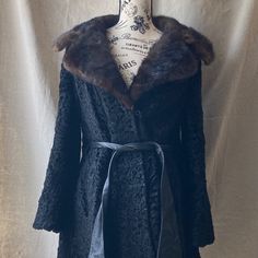 This Smashing Late 1960s Or Early 1970s Black Persian Lamb And Brown Mink Fur Coat Has An Amazing Shape, Wide Collar And Sleeves And A Leather Belt With Tapered Tips. This Is One Hot Coat And What Your Ultra Cool Mom Or Grandma Would Have Worn, But Her Mom Would Never Wear It. Persian Lamb Leather/Fur Body, Mink Collar And Leather Details, Trim And Belt. Has A Pocket On Each Side. From The Boston Store. In Overall Good To Well Loved Condition. She Has A Lot Of Life Left In Her But Needs A Little Tlc To Be An Everyday Winter Coat. Notes And Conditions: Small Seam Tear On Right Shoulder And In Right Armpit, Both On Seams And Repairable. Various Spots On The Lamb Fur That Are Shiny Or S Elegant Fall Outerwear For Vintage Fashion, Elegant Vintage Fashion Outerwear For Fall, Retro Fall Evening Outerwear, Retro Evening Outerwear For Fall, Fitted Winter Outerwear For Vintage Fashion, Vintage Winter Outerwear For Formal Occasions, Vintage Winter Evening Outerwear, Fitted Vintage Fall Outerwear, Fitted Vintage Outerwear For Fall