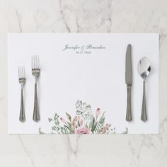 a place setting with silverware and flowers