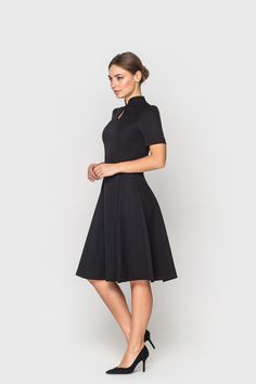 "A modern qipao dress featuring fit and flare silhouette, high neck mandarin collar and a midi length. - Fit and flare silhouette - Keyhole neck - Stand collar - Short sleeves - Midi length - Color: Black Fiber: viscose - 60%, elastane - 5%, polyester - 35% Concealed back zipper closure For Size S: dress length - 39\", sleeve length - 9\" (1/3) Our model wears size S (US 6) and is 171 cm/5'6\" tall. You may feel free choosing the size. Just send us your measurements (bust, waist, hips, height). Modern Office Wear, Office Wear For Ladies, Modern Qipao Dress, Chinese Cheongsam Dress, Mandarin Dress, Dress Professional, Mandarin Collar Dress, Modern Qipao, Professional Dress