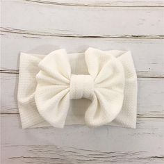 The Oversized Bow Headband for baby infant toddler girls White Adjustable Bow With Butterfly Knot, Adjustable White Satin Bow, White Headband With Bow Tie, White Bow Tie Headband, Playful Adjustable Bow Headband, Adjustable White Bow Tie Headband, Cute White Headband With Bow Tie, White Cotton Hair Accessories For Gifts, White Cotton Hair Accessories For Gift