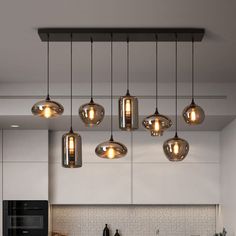 a kitchen filled with lots of lights hanging from the ceiling