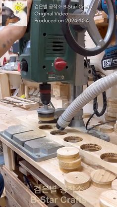 a person using a driller to cut wood with a grinder on the table