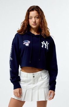 PacSun exclusive! Rock your team spirit with the MLB Wild Collective x PacSun Cropped Hoodie. This hoodie combines a relaxed fit and a drawstring hood for cozy coverage. Featuring baseball team graphics throughout, ribbed cuffs, and a cropped fit, it's perfect for showing off your style and support in a relaxed, sporty way.Solid color hoodieLong sleevesDrawstring hoodCustom graphicsCropped lengthRibbed cuffs80% cotton, 20% polyesterMachine washableModel is wearing a size smallModel measurements: 5’6.5” height, 32” bust, 23” waist, 35” hips Womens MLB Wild Collective x PacSun Cropped Hoodie - Blue size Large Team-colored Hooded Top For Streetwear, Game Day Fan Apparel Tops With Drawstring Hood, Collegiate Hooded Top For Sports Events, Sports Team Logo Hoodie For Sports Season, Sports Fan Apparel Tops With Drawstring Hood, Collegiate Crew Neck Top With Drawstring Hood, Sports Fan Apparel Top With Drawstring Hood, Fan Apparel Tops With Drawstring Hood For Sports Events, Collegiate Hooded Tops For Game Day