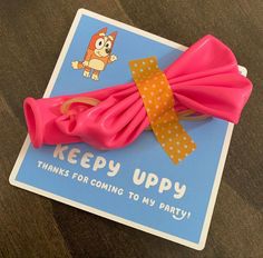 a pink bow with polka dots on it and a card that says, keep uppy thanks for coming to my party