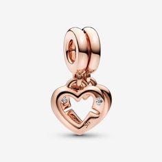 Show off your sisterly bonds with the Linked Sister Hearts Split Dangle Charm. Finished in warm 14k rose gold plating, this charm includes two linked open hearts, each featuring a sparkling clear cubic zirconia stone and engraving (one says "Sis" and the other reads "Sister"). On the back, each heart has small heart-shaped cut-outs and is engraved with "I will always have a friend". The hearts can be separated, so one can be gifted to your sister –a reminder of your forever bond. - Pandora Linked Sister Hearts Split Dangle Charm - 14k Rose gold-plated unique metal blend / Cubic Zirconia / Clear Bond Style, Sisters By Heart, Bracelet Pandora, Rose Gold Heart, Custom Pendants, Exclusive Jewelry, Pandora Bracelets, Small Heart, Dangle Charms