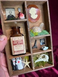 a miniature wooden box filled with different items