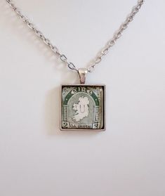 This pretty necklace is made from a genuine 1940s Irish postage stamp.  I love the detailed design of the stamp  . It makes a special gift for anyone who loves Ireland!  The antiqued silver-plated brass pendant measures about 13/16" x 13/16". A domed glass tile protects and enhances the vintage stamp's design. Please choose  your chain length above. Remove before contact with water. Each item comes lovingly wrapped and ready for gift-giving. Vintage Engraved Rectangular Pendant Necklace, Vintage Engraved Square Pendant Jewelry, Vintage Square Pendant Jewelry Engraved, Vintage Necklaces With Rectangular Pendant For Anniversary, Vintage Necklace With Rectangular Pendant For Anniversary, Vintage Engraved Square Pendant Necklace, Retro Sterling Silver Jewelry Gift, Retro Sterling Silver Jewelry For Gift, Retro Nickel Free Necklace For Gift