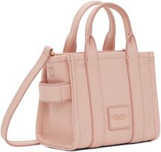 Grained leather tote in pink. Logo embossed at face. · Twin rolled carry handles at top · Detachable and adjustable shoulder strap · Carry handle at side · Logo patch at back face · Zip closure · Leather lining · Logo-engraved gold-tone hardware · H6 x W7 x D4 in Supplier color: Rose Pink Textured Leather Rectangular Bag, Pink Rectangular Textured Leather Bag, Pink Top Handle Bag With Textured Leather, Pink Textured Leather Shoulder Bag For Travel, Pink Textured Leather Top Handle Bag, Pink Textured Leather Rectangular Shoulder Bag, Pink Soft Leather Top Handle Satchel, Everyday Pink Textured Leather Bag, Pink Textured Leather Bag For Daily Use