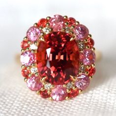 This 14K gold ring features a stunning pink tourmaline gemstone as the centerpiece, surrounded by sparkling pink spinel accents. The band is crafted from durable 14K gold and the design is elegant and timeless. The combination of the pink tourmaline and pink spinel gems create a feminine and romantic look that is sure to be admired. The ring would be perfect for any special occasion or as a unique and meaningful gift. ------------------------------- Custom Work Timeline Steps to create your own Coral Engagement Ring, Pink Cocktail Ring, Engagement Ring Pink, Pink Engagement Ring, Pink Cocktail, Pink Spinel, Pink Tourmaline Ring, Pink Gem, Tourmaline Ring