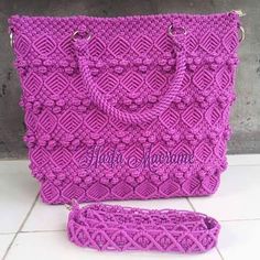 a purple handbag sitting on top of a white tile floor next to a bag