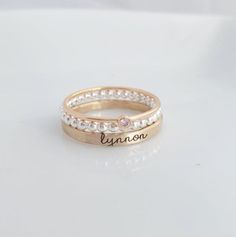 Mother's Day Gift | -the Isabelle- Personalized stackable ring set, engraved with a name, date, or special word.  Metal: .925 sterling silver, and 14k gold filled Dimensions: name ring is 2mm tall on average, but our rings are handmade so variations will occur. Birthstone is 2mm on a 1mm band. Font: lowercase typewriter Unsure what size you need? We highly recommend using our ring sizer for an accurate fit. Some people find that sizing up when stacking 3 or more rings is more comfortable. https: Personalized Rose Gold Stackable Rings, Personalized Rose Gold Stackable Rings With Round Band, Stackable Engraved Rose Gold Ring For Anniversary, Anniversary Stackable Engraved Ring In Rose Gold, Custom Name Adjustable Stackable Rings, Anniversary Rose Gold Stackable Engraved Ring, Adjustable Stackable Rings With Custom Name, Personalized Rose Gold Stackable Rings In Sterling Silver, Customizable Rose Gold Stackable Rings