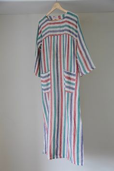 Incredible 70's made in Pakistan striped kaftan dress, you will live in this stunner all summer long! This really is a done-in-one kind of dress with the bests colours and sweet square pockets. It is a cotton/muslin sort of fabric. Condition is good, colour is still vibrant throughout. Unfortunately there are faint marks on the front and the sleeve of the garment, all of which are visible on photos, however they are not super obvious when worn. I didn't want to try and remove these marks myself Striped Long Maxi Dress For Summer, Bohemian Striped Kaftan For Summer, Bohemian Striped Tunic Dress, Striped Long Sleeve Kaftan For Summer, Striped Long Sleeve Summer Kaftan, Summer Striped Tunic Kaftan, Diy Sewing Clothes, Kaftan Dress, Muslin Cotton