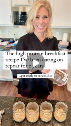 a woman standing in front of three jars filled with oatmeal and peanut butter