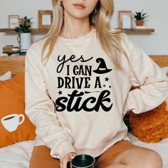 Show off your sense of humor this Halloween with our "Yes I Can Drive a Stick" sweater! Perfect for those who love a playful twist. This funny sweatshirt is sure to get laughs at any costume party. Made from soft, breathable fabric, it offers comfort while you celebrate the spooky season in style. Whether you're hitting the streets for trick-or-treating or just enjoying a festive gathering, this sweater is a fun addition to your Halloween wardrobe! Product features - Medium-heavy fabric blend of 50% cotton and 50% polyester for cozy warmth - Classic fit and crew neckline for a comfortable wearing experience - Double-needle stitching for durability - Ethically grown US cotton for sustainable production - Gray, tear-away label for itch-free comfort Care instructions - Machine wash: cold (max Funny Crew Neck Sweater For Fall, Funny Print Sweatshirt For Fall, Fall Sweatshirt With Funny Text And Crew Neck, Funny Text Crew Neck Sweatshirt For Fall, Fall Crew Neck Sweatshirt With Funny Text, Crew Neck Sweatshirt With Funny Text For Fall, Funny Fall, Witch Sweatshirt, Yes I Can