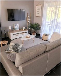 a living room filled with furniture and a flat screen tv mounted to the side of a wall