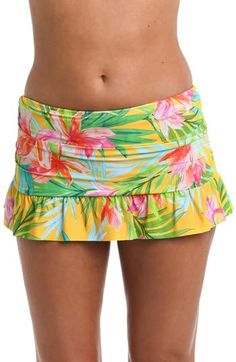 Built-in bikini bottoms ensure you feel confident while you lounge by the water in this ruffled swim skirt featuring a bold tropical pattern. Full back coverage Lined 83% nylon, 17% elastane Hand wash, line dry Imported Fitted Tropical Swim Trunks For Pool, Summer Stretch Swim Skirt With Ruffles, Summer Stretch Ruffle Swim Skirt, Summer Poolside Swim Skirt With Ruffles, Summer Ruffled Swim Skirt For Poolside, Stretch Tropical Bottoms With Floral Print, Tropical Stretch Bottoms With Floral Print, Tropical Stretch Floral Print Bottoms, Spring Beachwear Swim Dress With Ruffles