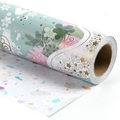 a roll of wrapping paper on top of a white surface with confetti sprinkles