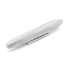 a white marble pen sitting on top of a table