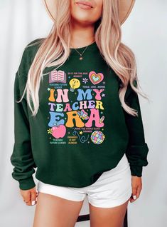 In My Teacher Era Sweatshirt, Teacher Custom Sweatshirt, Teacher Era Shirt, First Grade Teacher Sweatshirt, Back to School, Future Teacher  📢Please Check All Photos For Details.   📢Choose Your T-Shirt Size From The Drop-Down Lists Next To The item Picture   📢Choose Of Your T-Shirt Color From The 2nd Picture   📢Use "Add message to Seller" link On The Checkout Page To Send me the Following important Details For Your Order's Customization.   📢Shipping Time Varies by location (we are located in Relaxed Fit Long Sleeve School Top, Multicolor Crew Neck Sweatshirt With Screen Print, Multicolor Cotton Sweater With Letter Print, School Sweater With Letter Print And Long Sleeves, Multicolor Letter Print Sweatshirt Relaxed Fit, Multicolor Letter Print Relaxed Fit Sweatshirt, Green Graphic Print Tops For School, Green Letter Print Top For School, Multicolor Crew Neck Tops For College