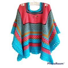 a colorful crocheted sweater hanging on a clothes line with the words photo room written below it