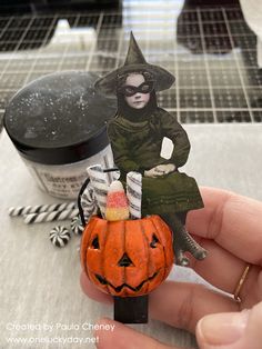 a person holding a fake halloween pumpkin in front of some ice cream and other items