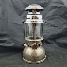 an old fashioned metal lantern on a black background