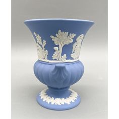 a blue and white vase sitting on top of a table