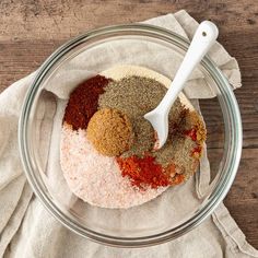 spices and seasonings in a glass bowl with a white spoon