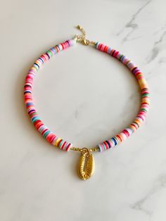 "The Nassau Choker is an adorable multicolor beaded choker! Heishi beads are stranded by hand onto a flexible stainless steel beading wire, and the necklace is entirely finished with shiny 24k gold plated hardware! The necklace measures approximately 14\" long and can be extended an additional 2\" to ensure a personalized fit!  Sky Blue Lagoon prides itself on quality craftsmanship and attention to detail, making our jewelry pieces wearable art made just for you! NOTE: This  is NOT waterproof, so make sure to take it off before showering or swimming! See the FAQ Section for additional care instructions to ensure that your piece remains bright and shiny for as long as possible! Thank you for visiting Sky Blue Lagoon! Make sure to check out our Instagram @skybluelagoon for updates and more!" Surfer Necklace, Bead Choker, Beading Wire, Bracelets Handmade Beaded, Heishi Beads, Silver Plated Jewelry, Nassau, Blue Lagoon, Beaded Choker