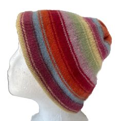 a multicolored striped hat on a mannequin head