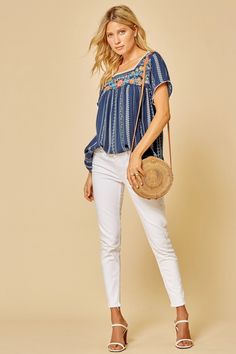 A beautiful top with summer-to-fall versatility. Navy Stripe Embroidered top with round Neckline Neckline has pom pom detail Flowy Fit & Non Sheer Rayon Casual Floral Embroidered Blouse For Vacation, Chic Embroidered Tops For Vacation, Casual Tassel Blouse For Spring, Spring Vacation Blouse With Embroidered Hem, Chic Embroidered Beach Tops, Chic Spring Vacation Embroidered Top, Spring Vacation Embroidered Neckline Top, Chic Embroidered Top For Spring Vacation, Chic Embroidered Top For Spring Day Out