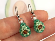 These beautiful beaded Avocado earrings are small and simple, which makes them perfect for everyday wear, but also suitable for special occasions.  ✤ SIZE (Approx.): ▸ Lenght: 2 cm (0.79 inches). ✤ MATERIAL: ▸ Brown crystal, dark green and light green seed beads (size 11/0). ▸ Strong and durable beading thread. ▸ High quality stainless steel ear wire. Please note that colors may appear slightly different due to variations in monitors and browsers. ✤ SHIPPING: ▸ I will ship as soon as possible, a Avocado Beaded Earrings, Beaded Avocado, Avocado Earrings, Olive Earrings, Miniature Fruit, Beading Thread, Food Earrings, Fruit Earrings, Earrings Summer