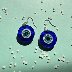 "Each earring is made of acrylic and attached to stainless steel, hypoallergenic ear wires. Each pair comes with a rubber earring back. Measures 1.5\" long." Blue Round Plug Earrings As Gift, Blue Round Plug Earrings For Gift, Blue Plastic Earrings For Gift, Blue Plug Earrings For Gifts, Blue Plastic Jewelry As A Gift, Nickel-free Round Resin Earrings, Trendy Hypoallergenic Clear Earrings, Nickel-free Plastic Earrings As Gift, Plastic Earrings For Gifts