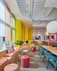 an office with brightly colored furniture and large windows