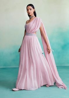 Introducing "bloomsy" - where elegance meets comfort! Our orchid pink bloomsy skirt saree is a one-of-a-kind creation, featuring a hand-embroidered bustier blouse adorned with mesmerizing double buttonhole stitches and shiny cutdanas. What sets this ensemble apart is its innovative design, allowing the dupatta to seamlessly attach to the skirt, granting you the look of a saree without the hassle of draping. Designer Dresses With Sheer Dupatta And Long Skirt, Designer Long Skirt Dress With Sheer Dupatta, Georgette Dress With Sheer Dupatta, Sheer Dupatta Long Skirt Dress For Reception, Pink Traditional Drape Dress For Spring, Pink Floor-length Pre-draped Saree With Zari Work, Reception Dress With Sheer Dupatta And Long Skirt, Reception Dress With Sheer Dupatta, Traditional Pink Dress For Spring