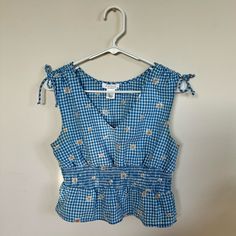 Adorable Blue Checkered Embroidered Shirt With Smocked Waist And Bow Ties On Shoulders. Absolutely Obsessed With The Embroidery Detail! Never Worn, Nwot. Size Medium Ptp: 16” To 19” With Stretch Model Is Size Xs So Shown Modeled Slightly Oversized Smoke Free Home All Items Washed Before Shipping Send Offers!! :) Casual Gingham Smocked Top With Ruffles, Spring Plaid Smocked Top With Ruffles, Summer Gingham Smock Top, Summer Smock Gingham Tops, Spring Gingham Smocked Top With Smocked Bodice, Spring Gingham Top With Smocked Bodice, Spring Gingham Smock Top, Spring Gingham Smocked Top, Casual Gingham Tops With Smocked Bodice