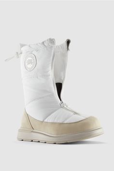 a pair of white snow boots sitting on top of each other