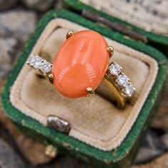 This classy bypass ring features an oval cabochon salmon colored coral with six round brilliant cut diamond accents. It is crafted in 14k yellow gold and currently sized to a 6.5. Coral Gold Ring For Women, Elegant Oval Coral Rings, Luxury Elegant Coral Rings, Elegant Coral Ring Jewelry, Coral Stone Ring, Antique Cocktail Ring, Ring Jewellery Design, Bypass Ring, Coral Ring