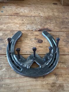 an old metal object sitting on top of a wooden floor