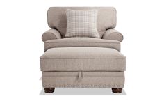 a chair with a footstool and pillows on it's backrest, in front of a white background