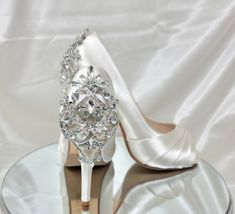 "Bridal Shoes with crystal back design. Dyeable Wedding Shoes.  Shoes in listing are Light Ivory.  Wedding shoes available in over 100 additional colors, including white.  We can also color match a sample you send us.   If you pick chart color or David's Bridal color from the menu, please put the color you would like in the personalization box. These beautiful wedding shoes have a 4 1/4\" heel and a 1/2\" hidden platform. Pick from my color chart or send us a color swatch to match. DYE COLORS: M White Satin Wedding Shoes, White Crystal Embellished Shoe Clips For Wedding, Glamorous White Shoe Clips For Wedding, White Glamorous Wedding Shoe Clips, Glamorous White Wedding Shoe Clips, Elegant Wedding Shoes With Rhinestones For Bride, Elegant Rhinestone Wedding Shoes For Bride, White Crystal-embellished Wedding Shoes, Elegant Cream Heels For Bride