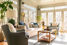 a living room filled with furniture and lots of windows