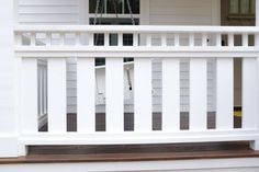 a white picket fence on the front porch