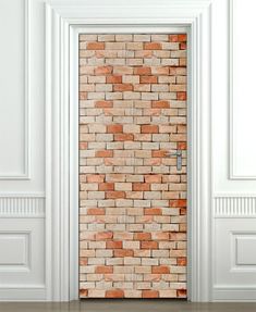 an open door to a brick wall in a room with white walls and wood floors