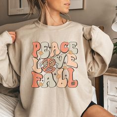 This trendy, retro style Fall Sweatshirt feature the saying Peace, Love, Fall and a cute 70s vibe. Comes in multiple colors! Find more styles here: www.etsy.com/shop/jadeandroseshop ❤️ Please note that for the oversized look you need to buy 1-3 sizes larger than you normally wear. If you prefer the standard Unisex fit order your typical size. For women, if you prefer a more women's fit sweatshirt please size down 1 size, as this sweatshirt is a Unisex fit ❤️ This unisex heavy blend crewneck swea Peace Love Fall, Speech Shirts, Football Sweatshirt, Love Fall, Speech Language Pathologists, Trendy Fall, Thanksgiving Shirts, Fall Sweatshirt, Workout Sweatshirt